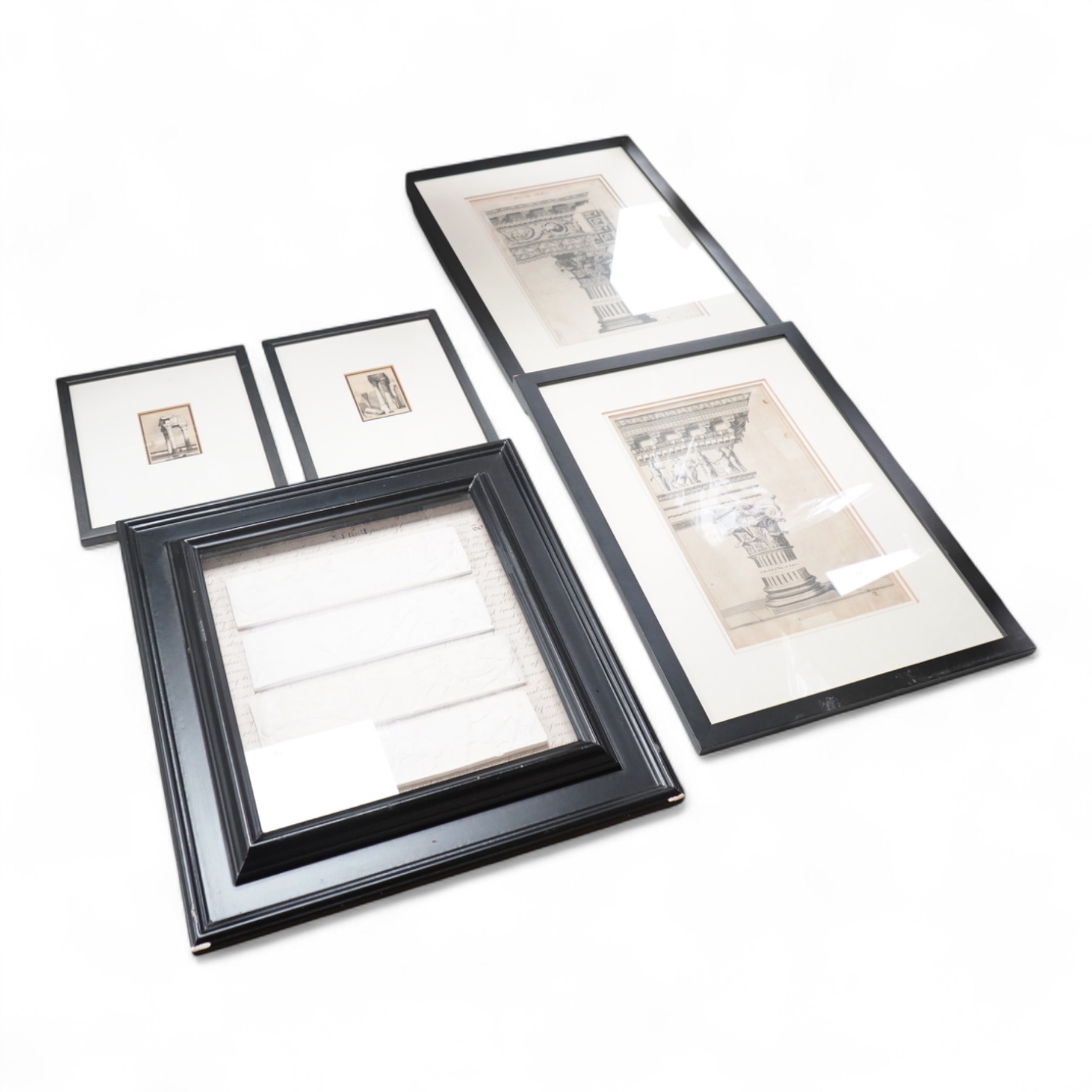 A set of four plaster plaques depicting classical scenes and four 18th/19th century architectural etchings, framed, largest 43cm high